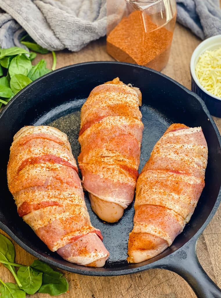 uncooked stuffed chicken breasts in a pan