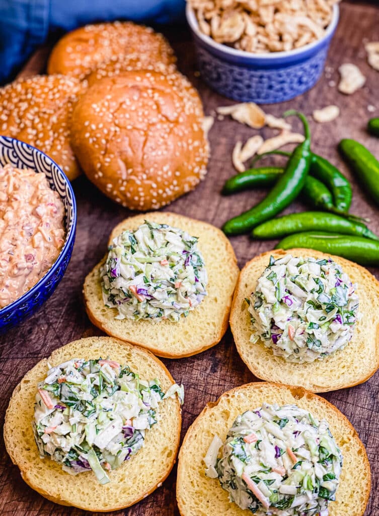 buns being prepared with slaw for pimento cheeseburgers