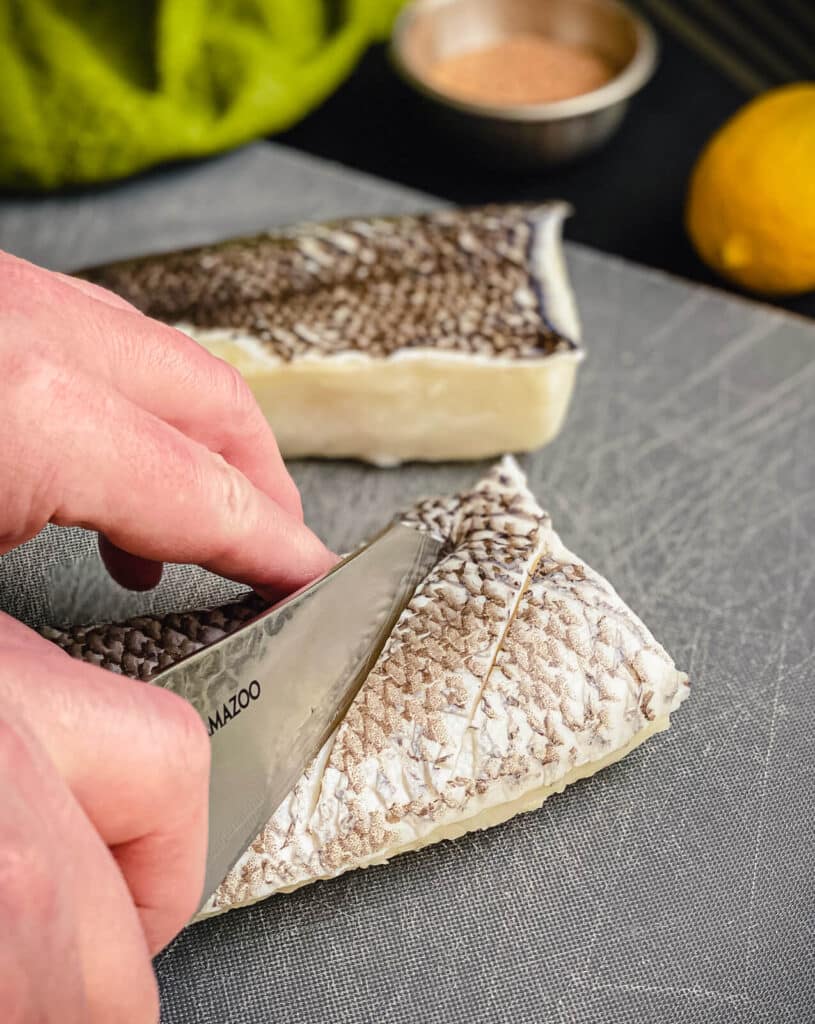 slicing small slits into the skin of chilean sea bass