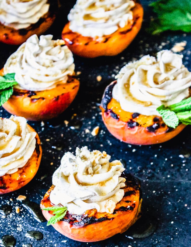 fresh grilled peaches on a  cutting board with ice cream