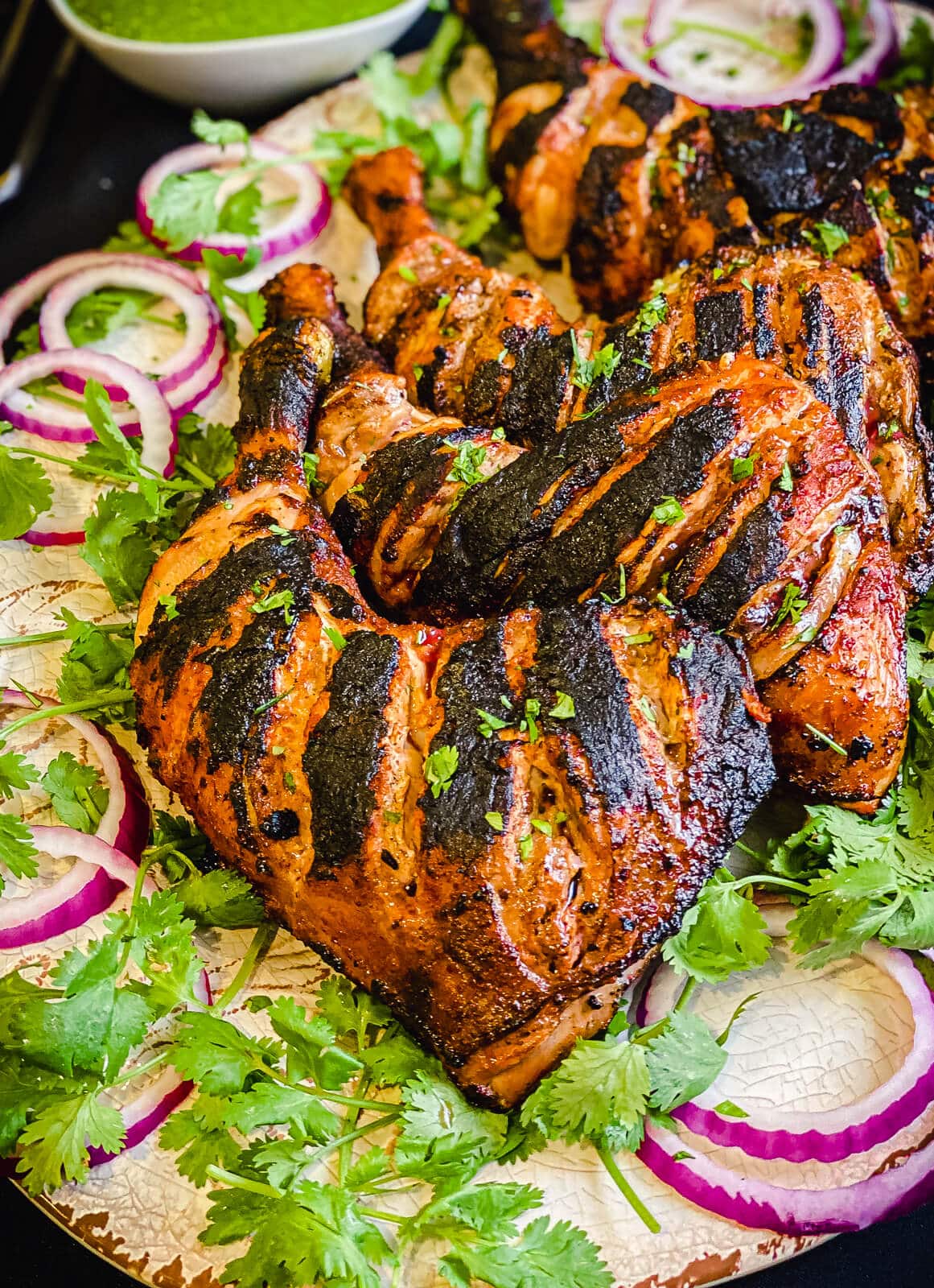 grilled tandoori chicken on a serving platter