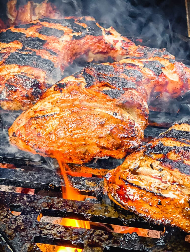 chicken tandoori being grilled over flames