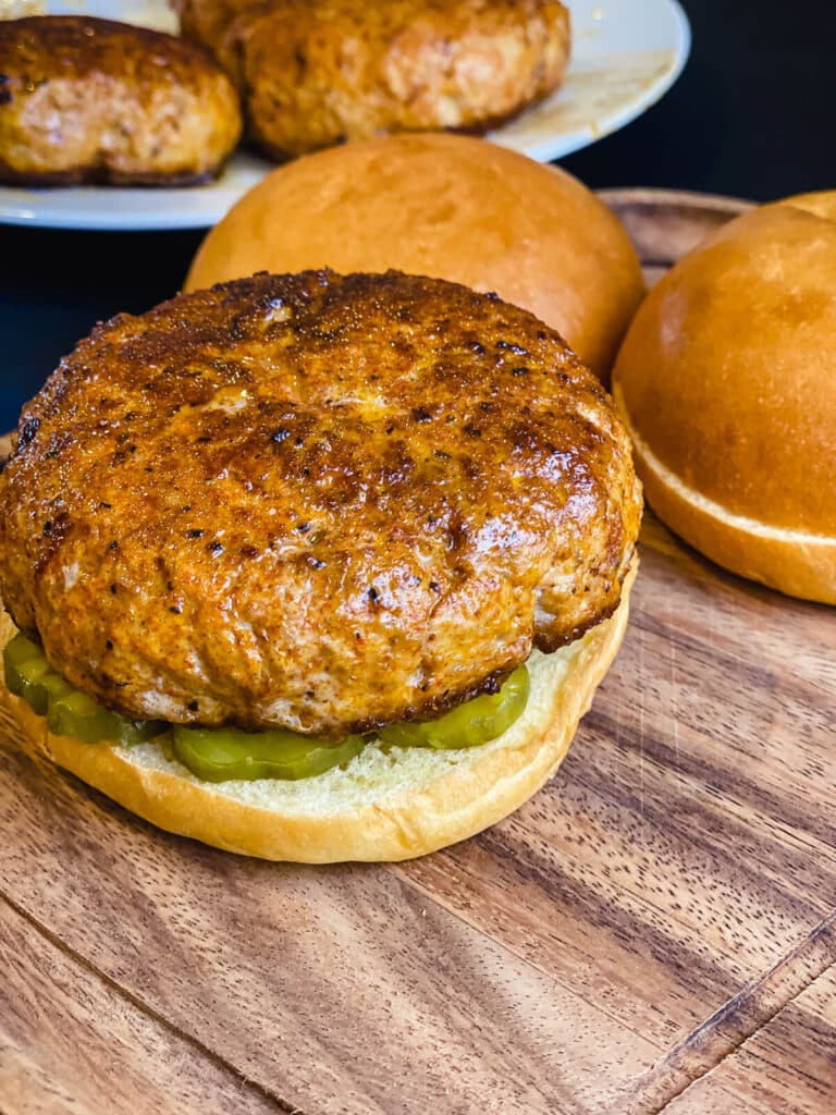 Nashville hot chicken burger on a top of pickles on a bun