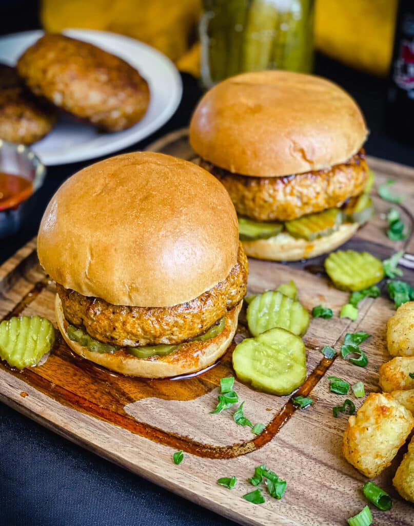 Nashville hot chicken burgers on a wood plate