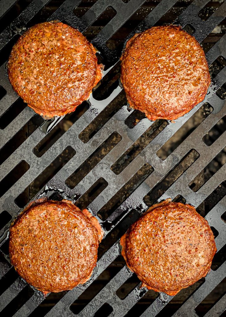 pimento cheeseburgers on the grill over indirect heat.