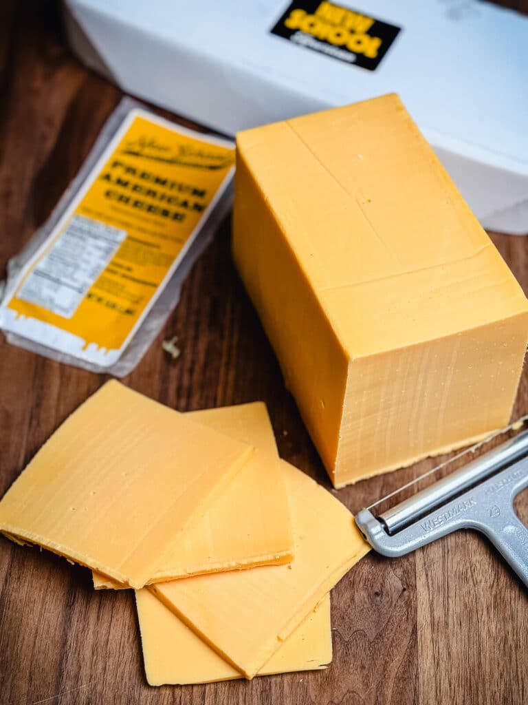 Slices of American cheese on a cutting board