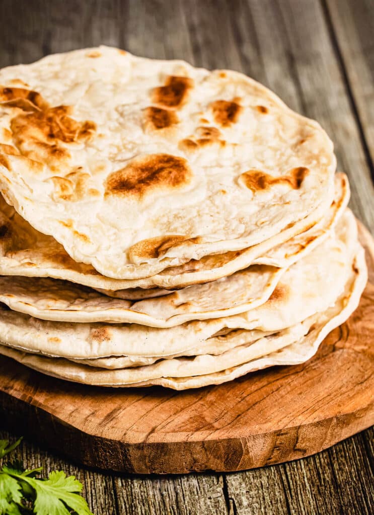 stack of naan bread on a cutting board