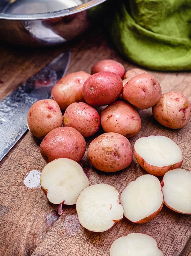 sliced parboiled potatoes on a cutting board