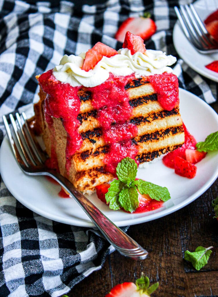 plate of grilled angel food cake with strawberry puree and mint