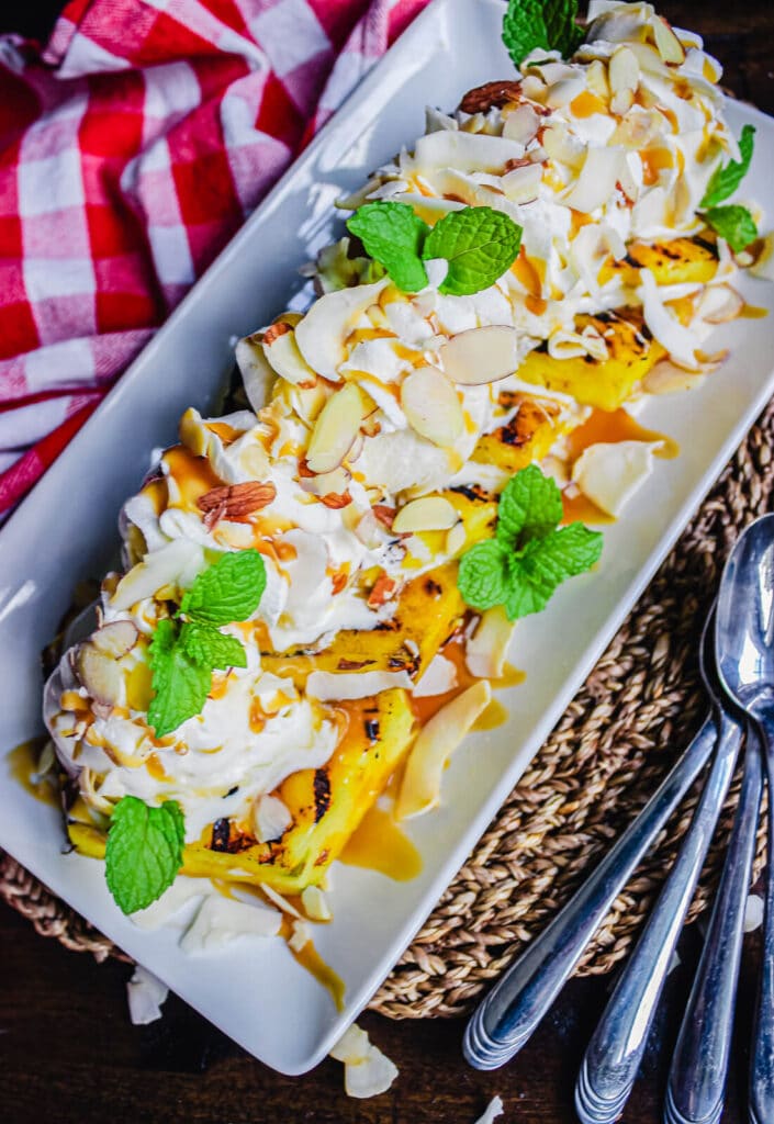 grilled pineapples with ice cream served on a platter