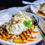 grilled pineapple with ice cream on a white plate
