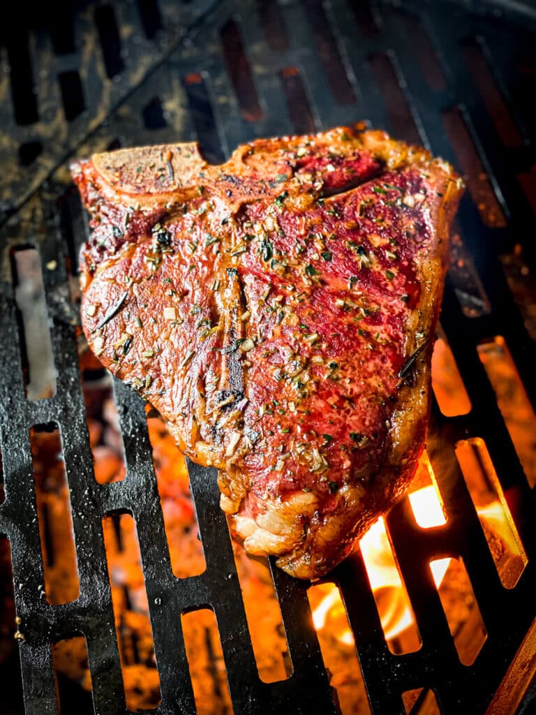 porterhouse steak over hot coals
