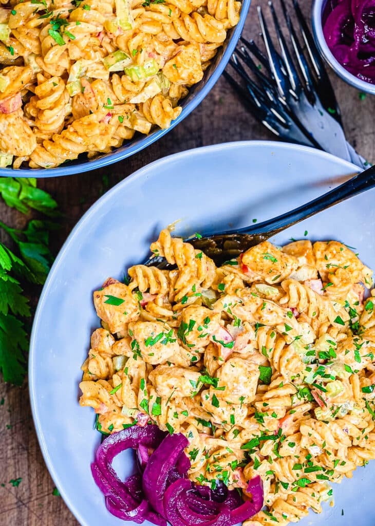 overhead shot of a chicken pasta salad in two large bowls