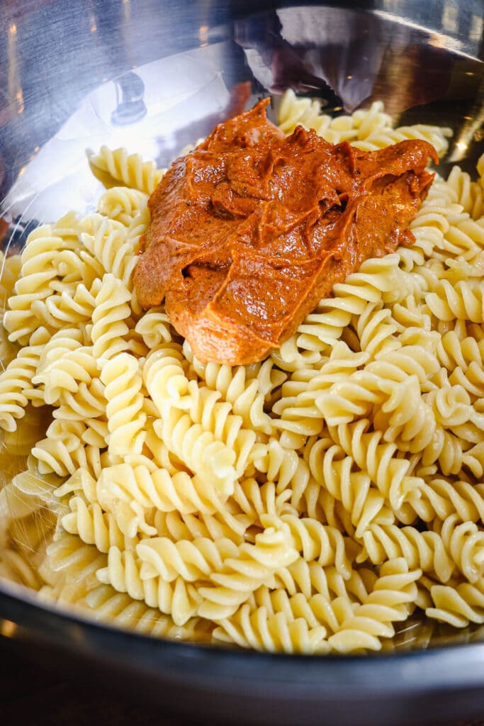 Nashville hot chicken dressing added to warm pasta