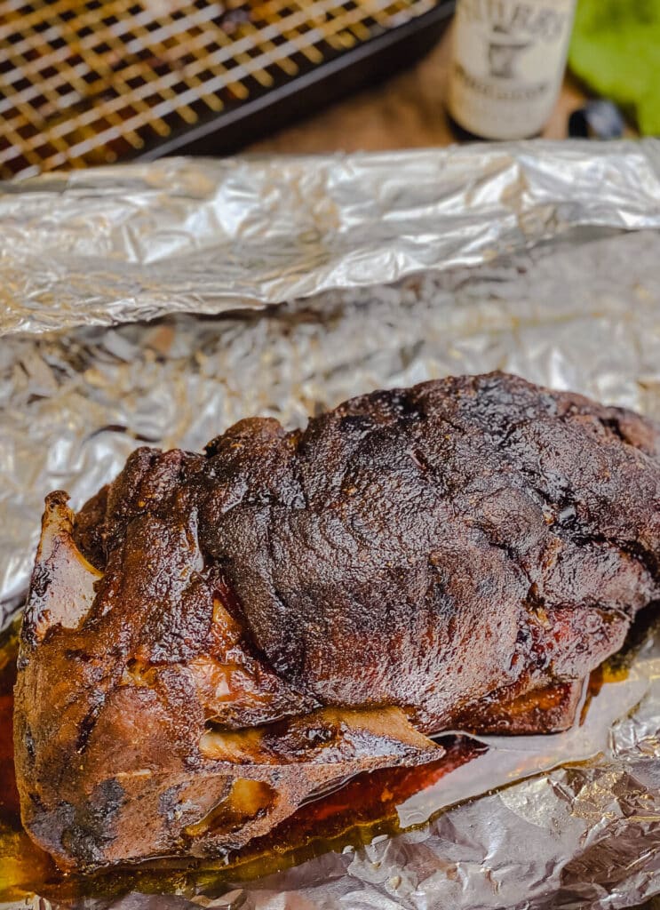 roasted pork shoulder sitting on aluminum foil