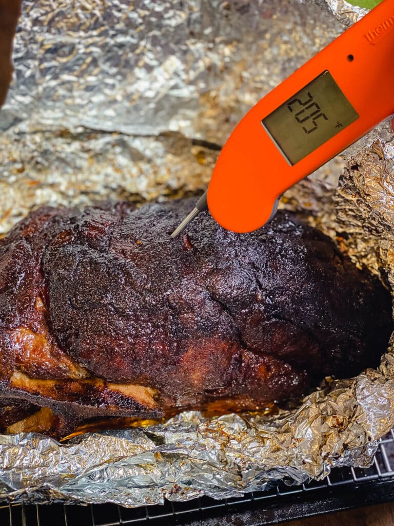roasted pork butt with a thermometer inserted