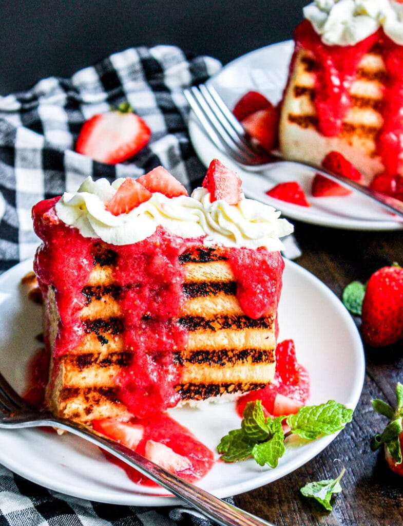 grilled angel food cake with strawberry puree on a table with mint