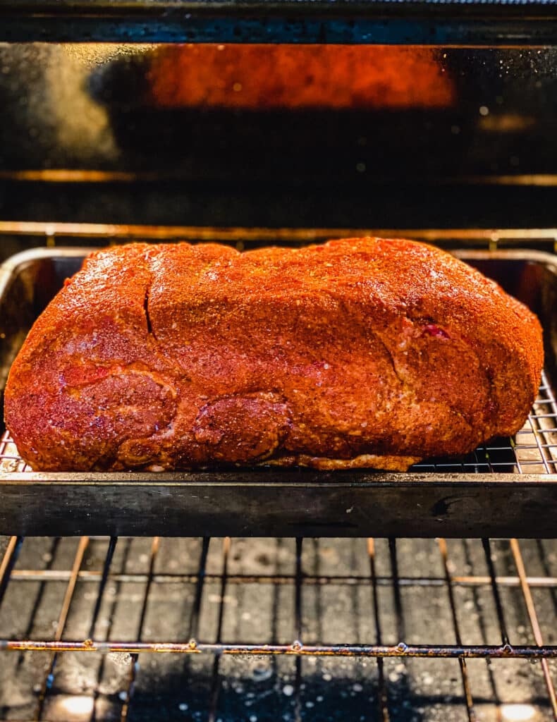 pork shoulder cooking in an oven