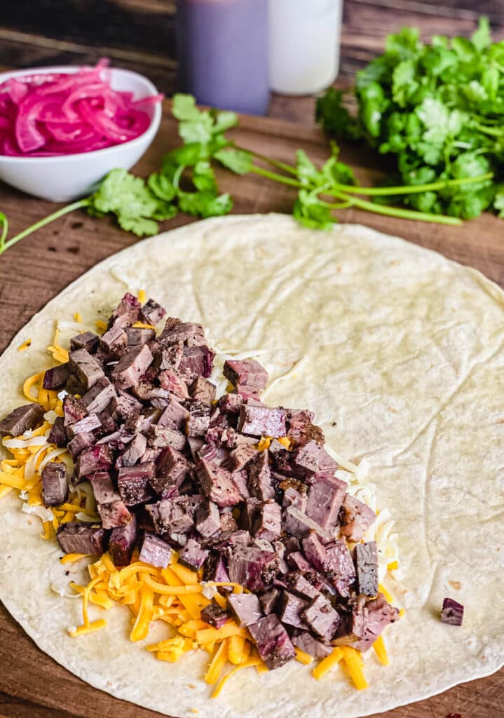 leftover steak added to a tortilla for a quesadilla