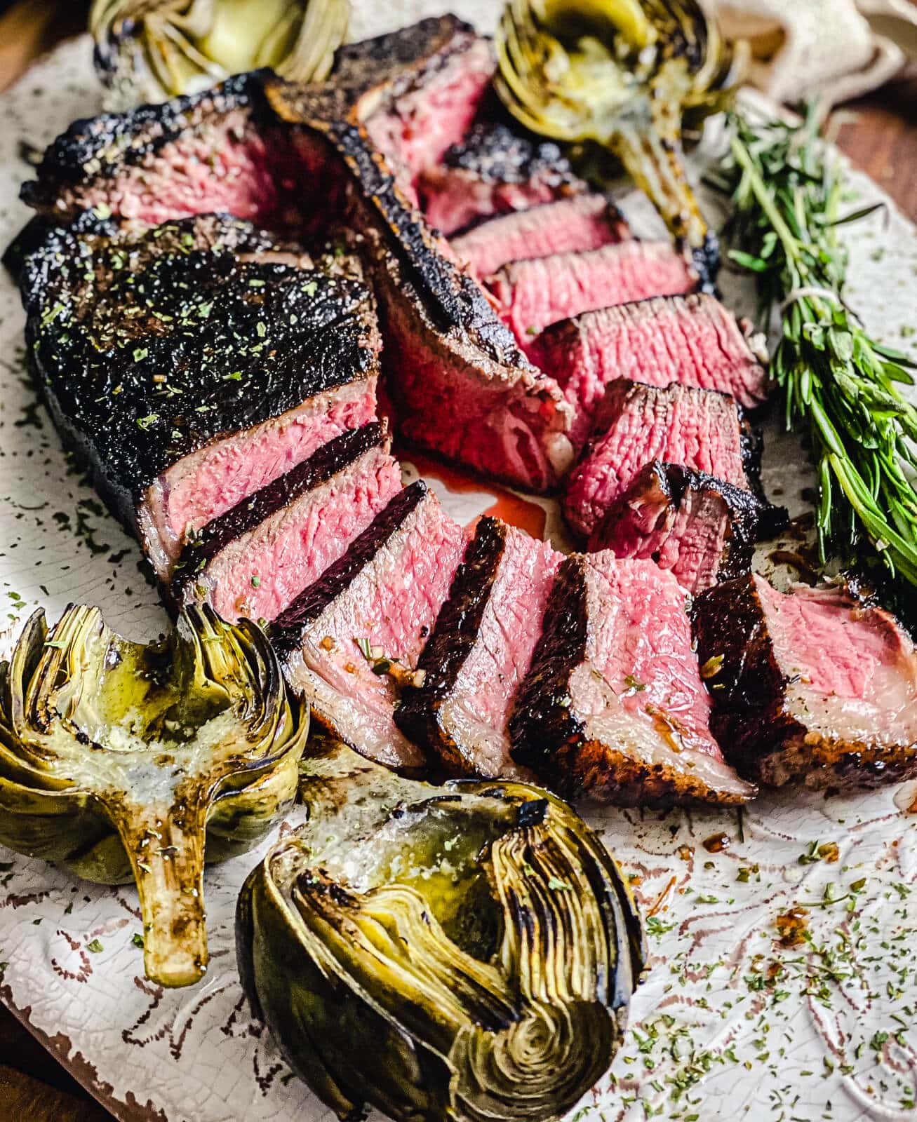 sliced tuscan style porterhouse on a platter