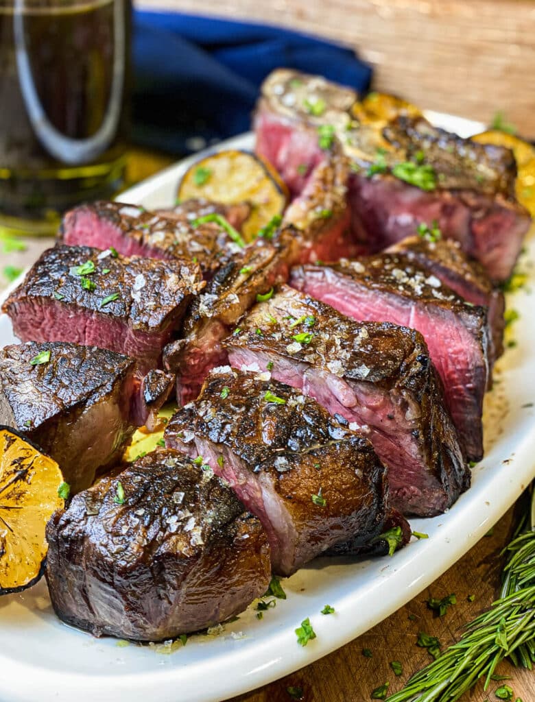 sliced steak florentine on a platter, garnished with parsley