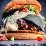Mexican burger topped with roasted poblano pepper, queso, and pico