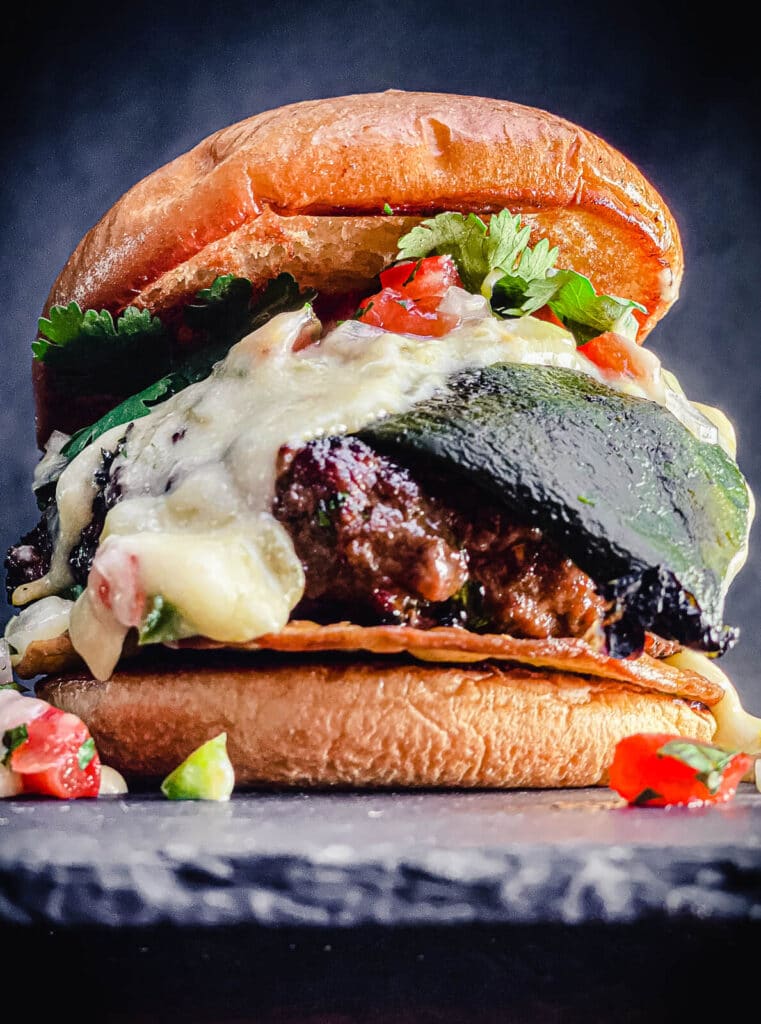 Mexican burger topped with roasted poblano pepper, queso, and pico