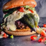 Mexican burger sitting on a black slate surface