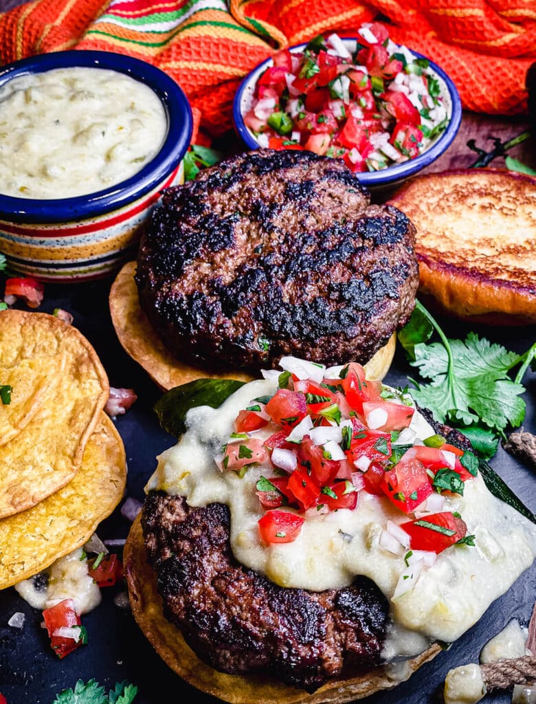 Mexican burgers being assembled on a black surface