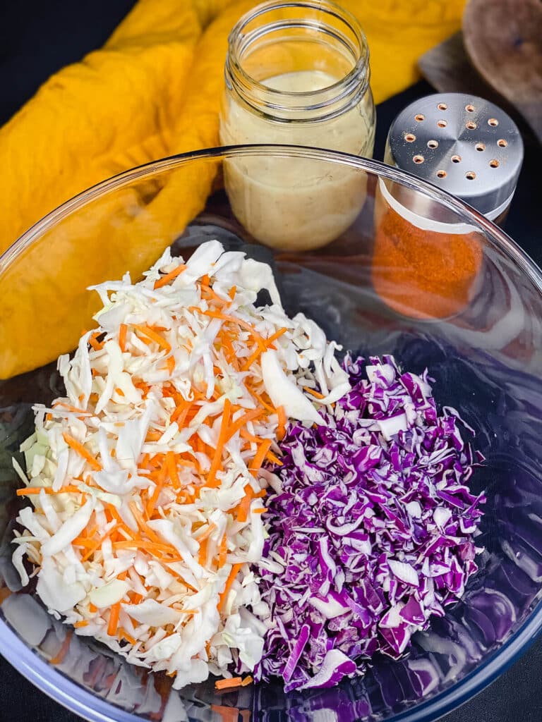 ingredients for the best coleslaw recipe in a glass bowl