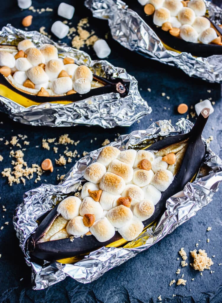 cutting board with grilled banana splits and brown sugar