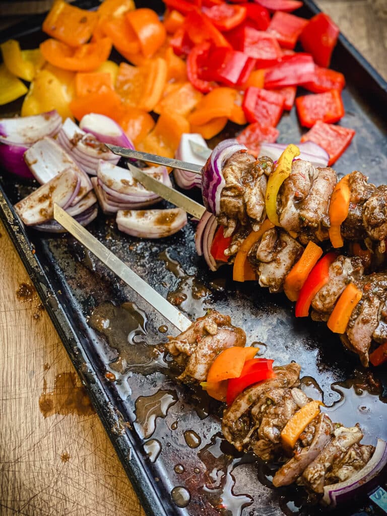 jerk chicken skewers on a tray