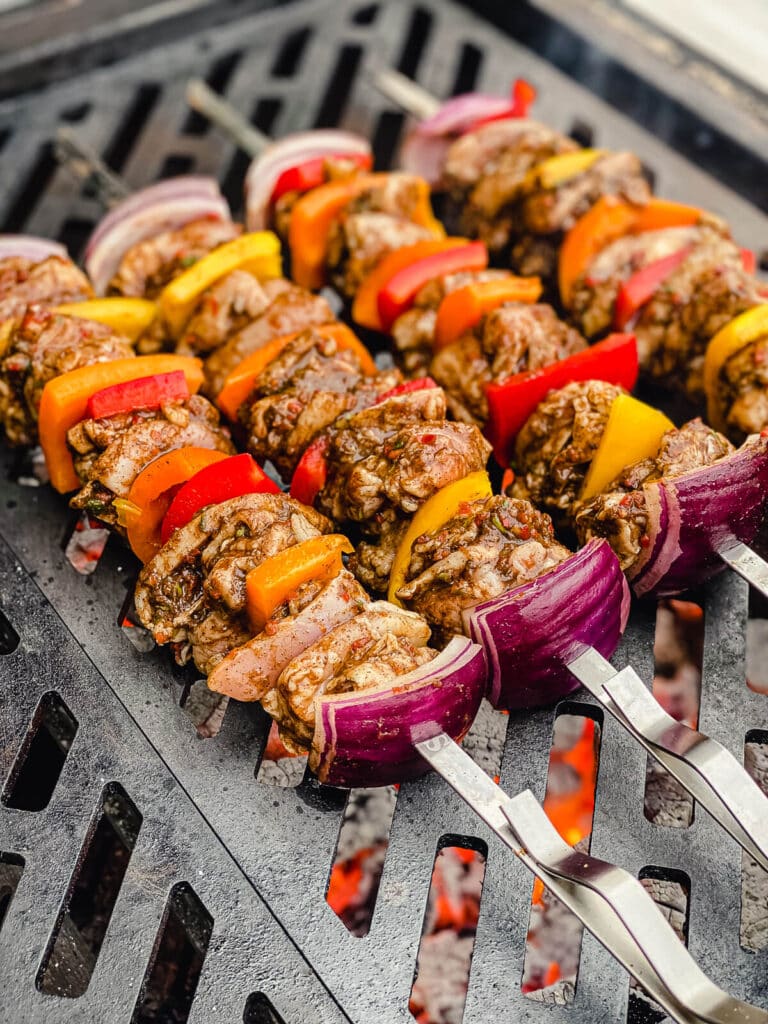 chicken kabobs on the grill over fire