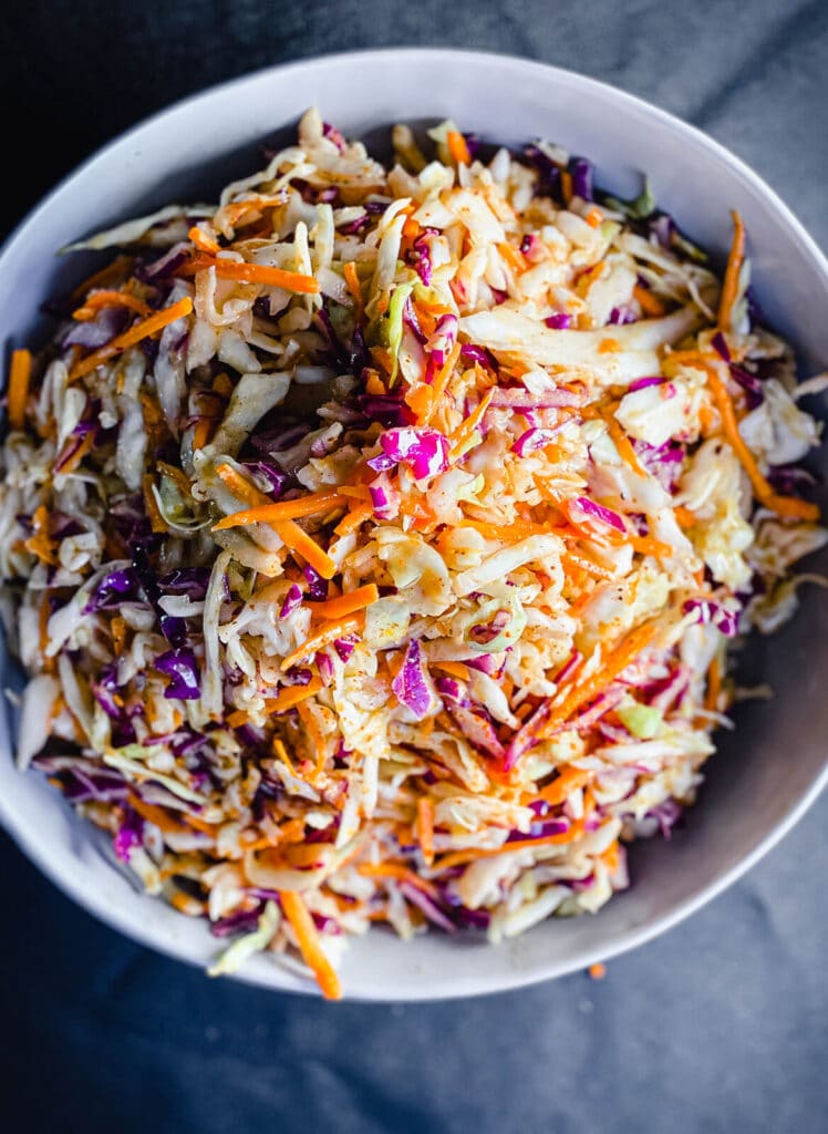 bowl of Nashville hot coleslaw on a black table