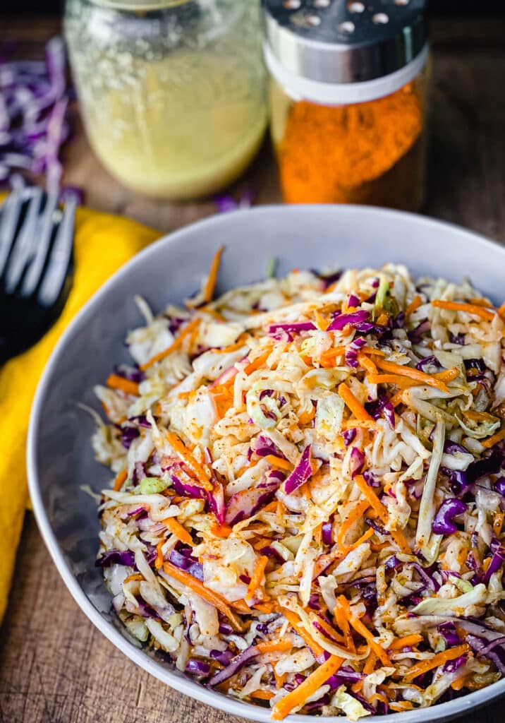 Nashville hot coleslaw in a bowl with a yellow napkin sitting next to it