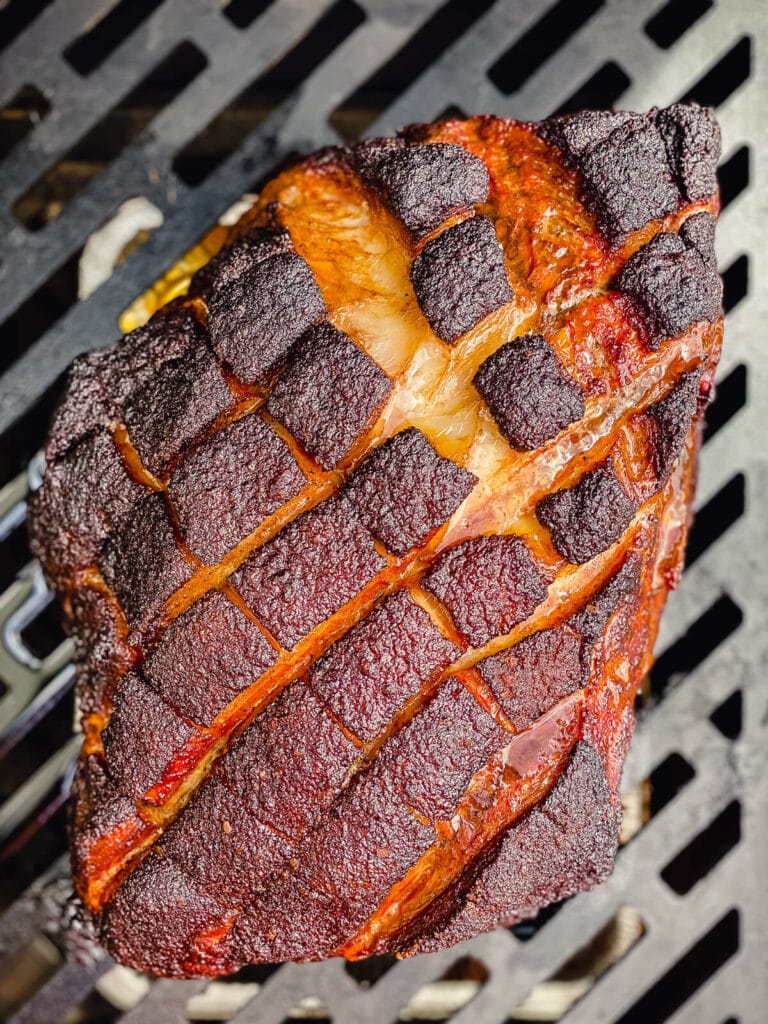 apple juice brined park shoulder on the grill with crust forming on the fat cap