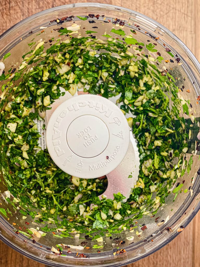 chimichurri ingredients chopped up in a food processor
