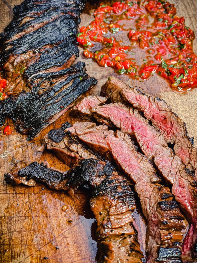 sliced churrasco steak on a cutting board