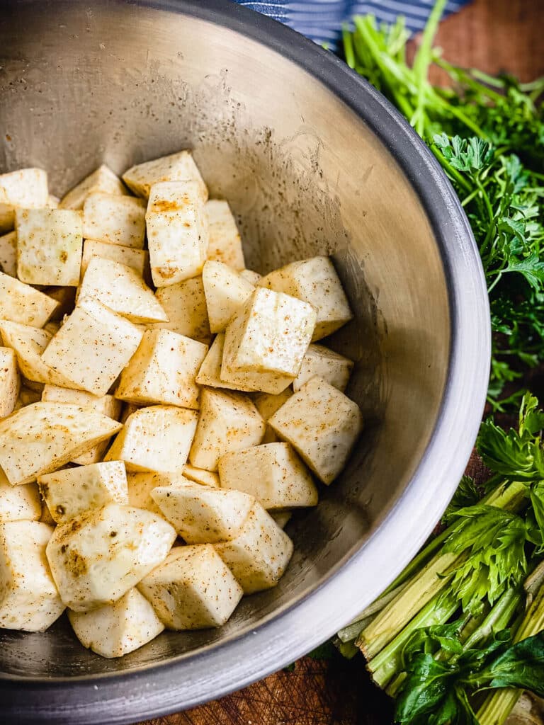 diced and seasoned celery root in a bowl