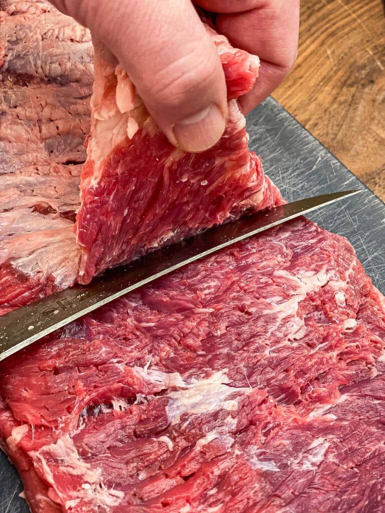 fat being trimmed from flap meat