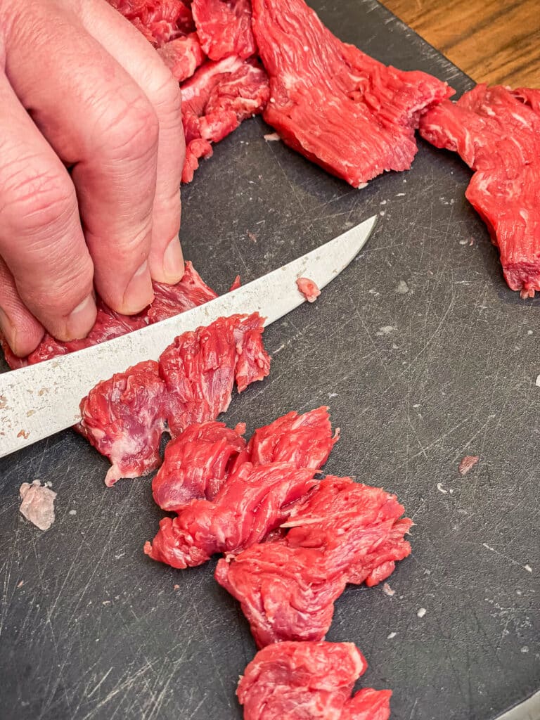 flap meat being sliced for stir fry