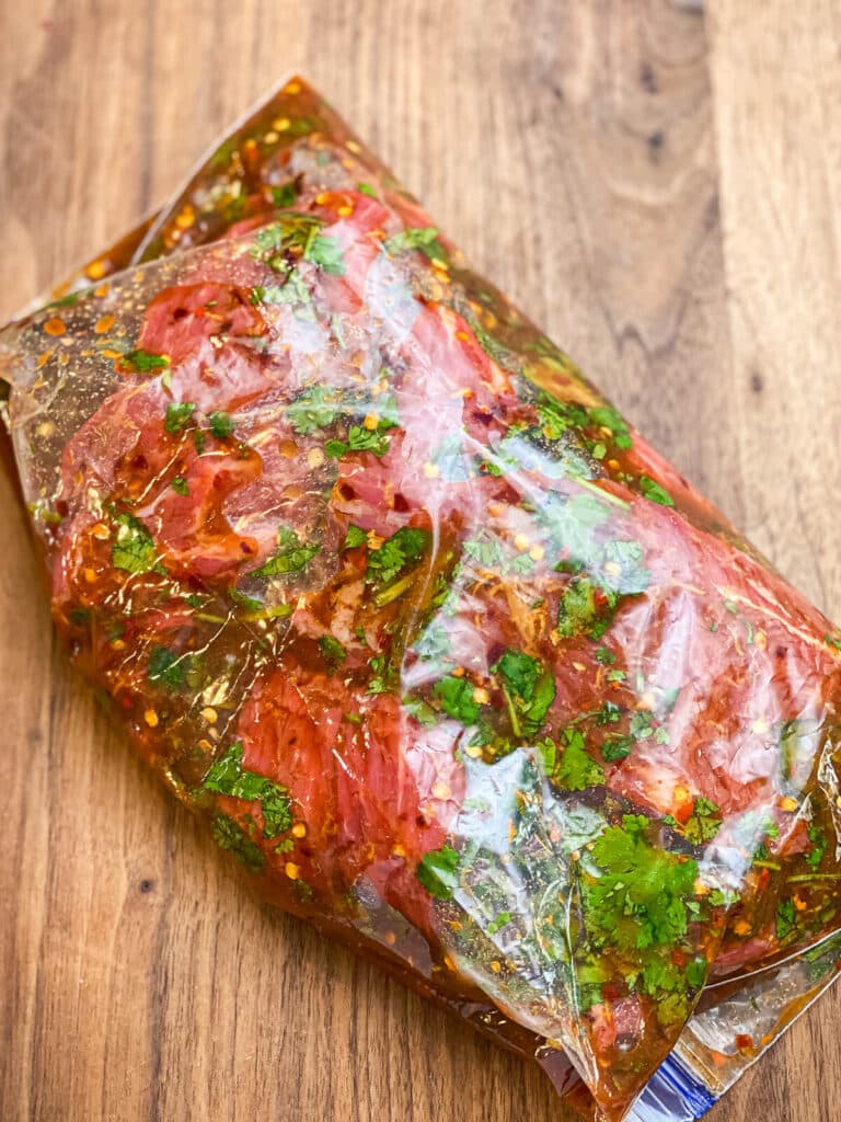 beef marinating in a plastic bag