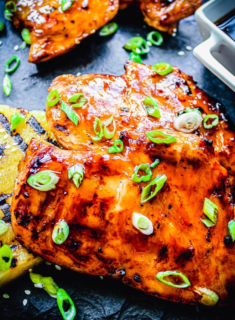 charred chicken thighs with sauce and pineapple