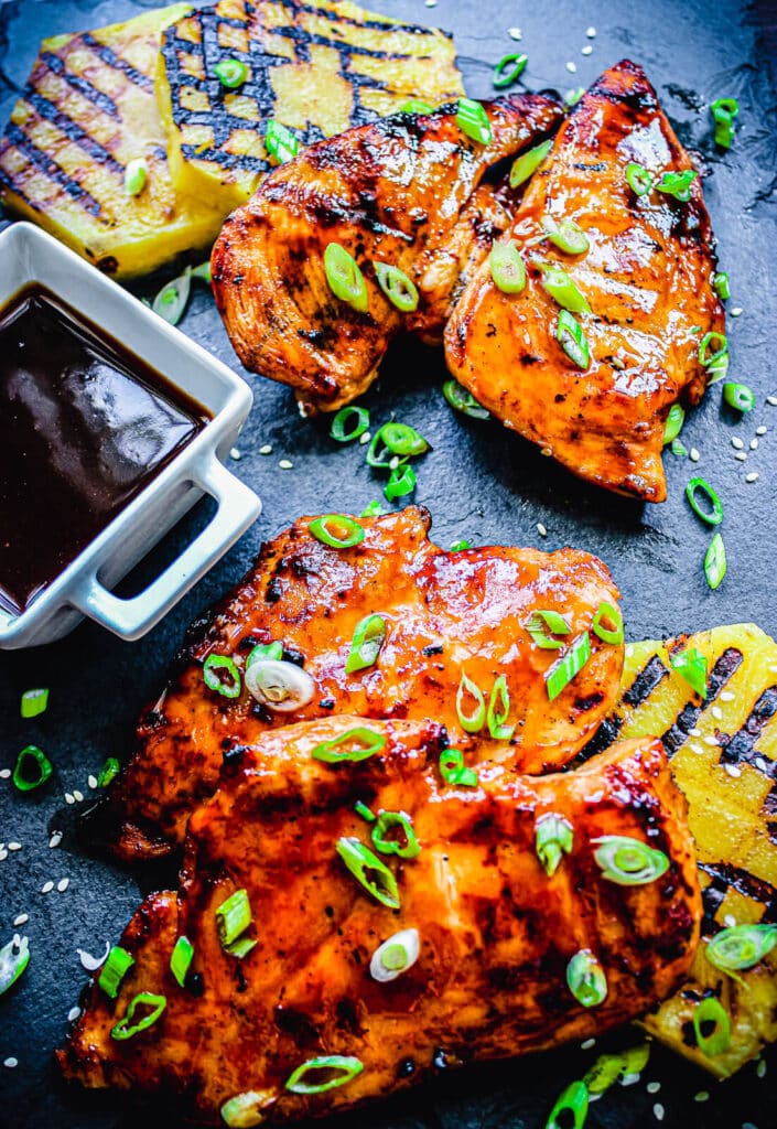 grilled chicken thighs with sauce and grilled pineapple
