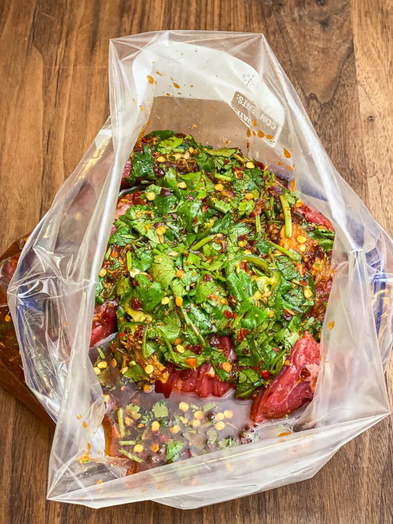 flap meat in a bag covered with marinade.