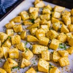 Roasted celery root on a baking sheet with parsley