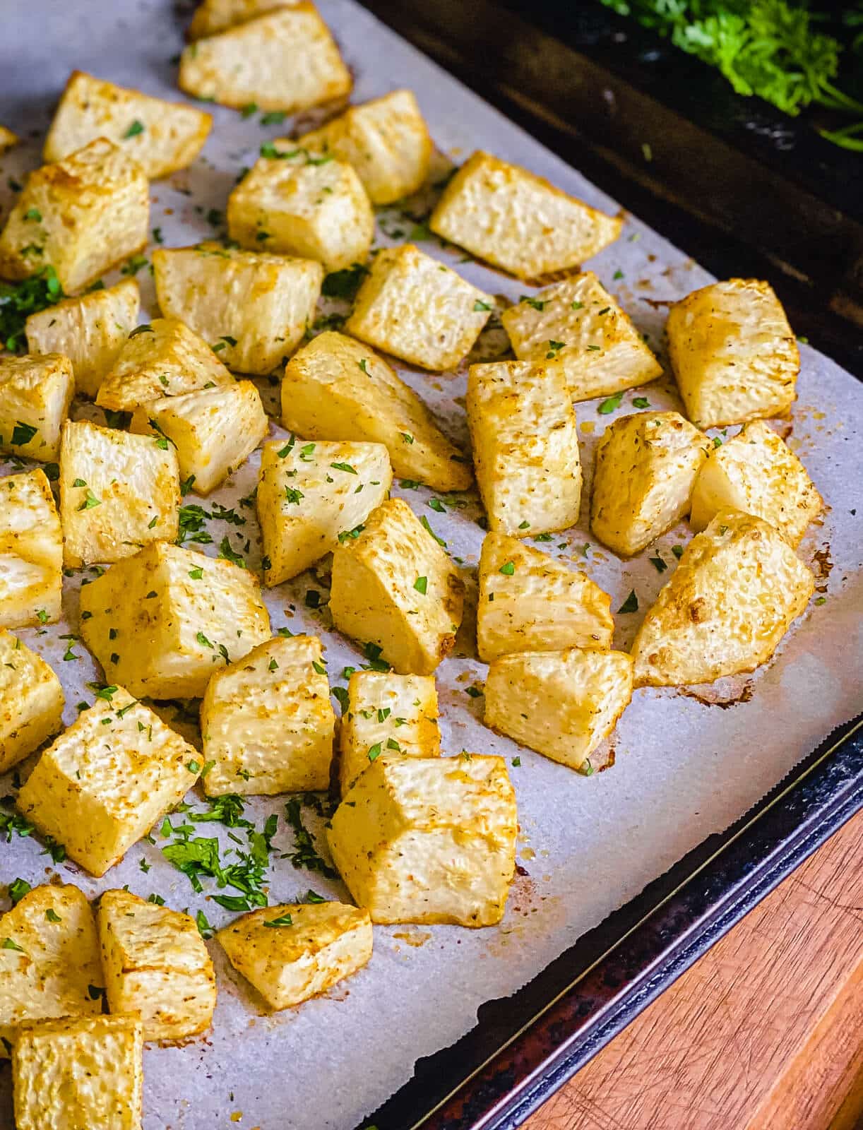 roasted celery root chunks on a baking sheet