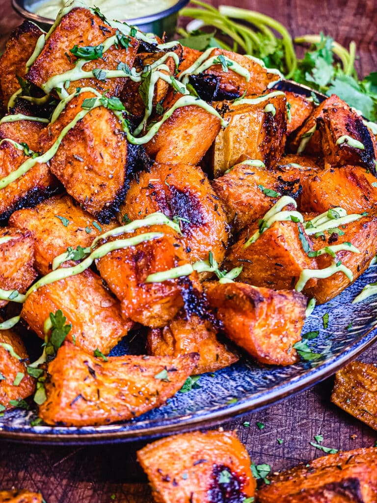 close up shot of a plate full of roasted sweet potatoes