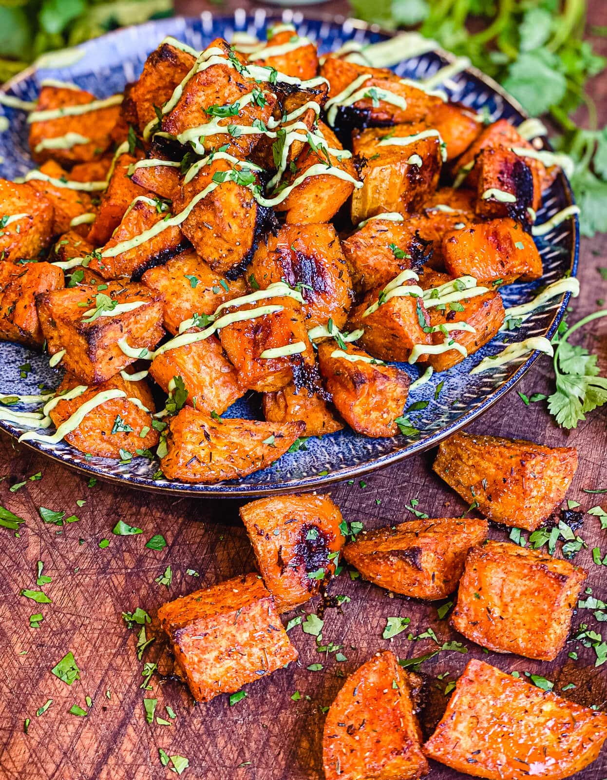 roasted sweet potatoes and avocado cream on a plate