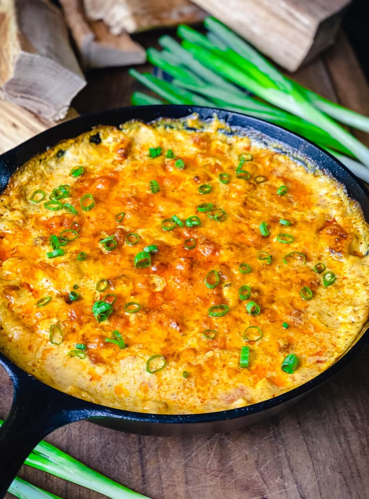 smoked buffalo chicken dip in a cast iron pan